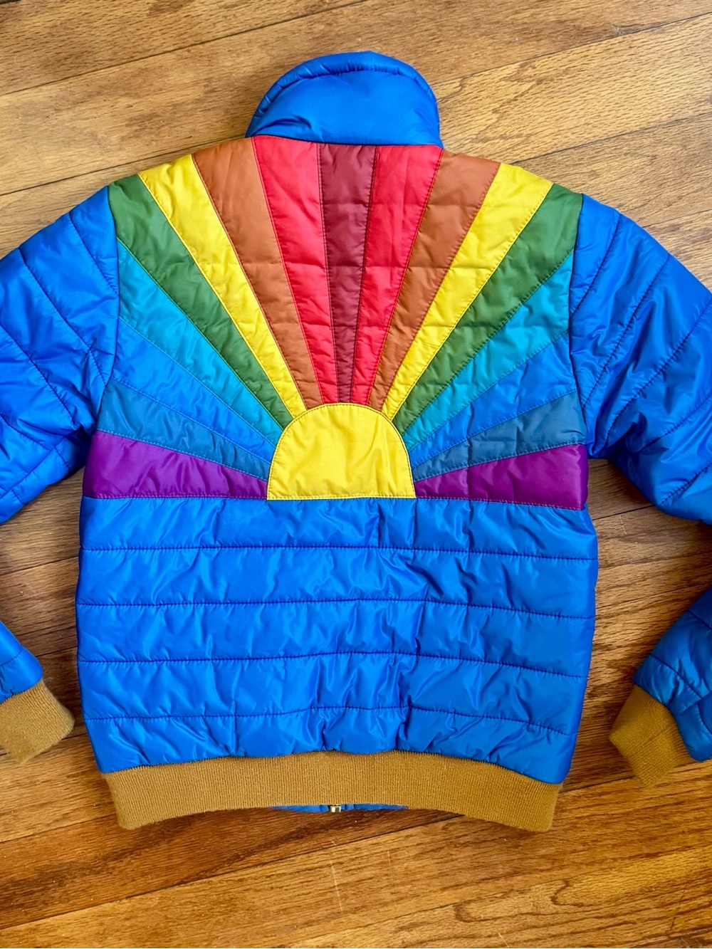 Aviator Nation Blue Puffer Jacket with Rainbow Sunburst